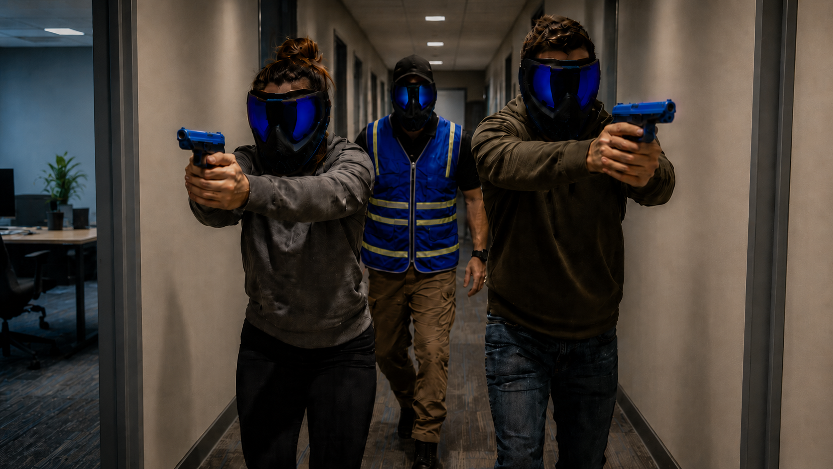 Three trainees in protective masks during force-on-force hallway training
